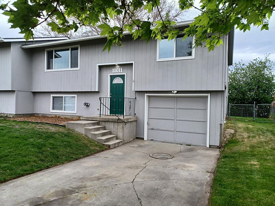 Front entry showing 1 car garage and off street parking.