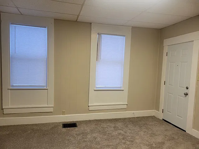Living room and entry door on the right.
