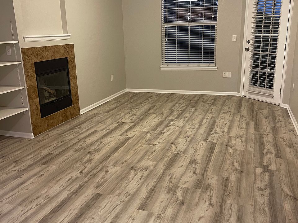 Living area with fireplace leading out to main balcony. New flooring and new paint throughout