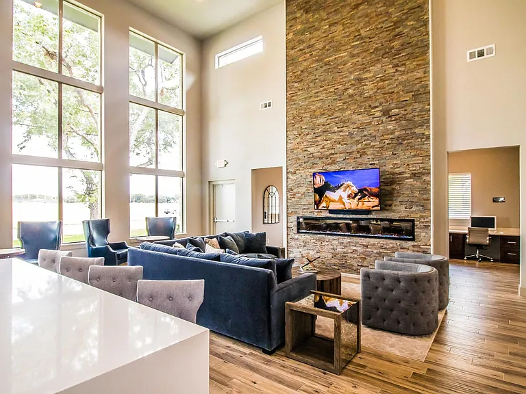 Enjoy stylish interiors with a fireplace, tall windows, and cozy seating.