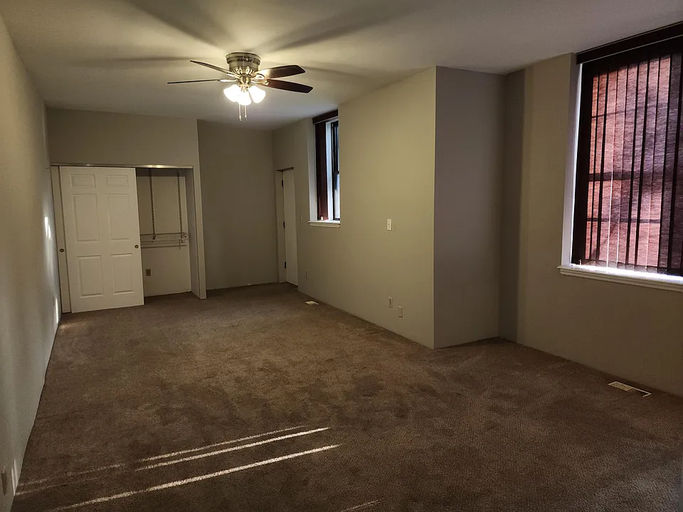 Main level master bedroom. An unusually large space for a bedroom! An office or exercise area would fit too. There's a door that opens to the balcony