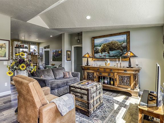 Entry has vaulted ceilings. Living room opens to kitchen in the background.