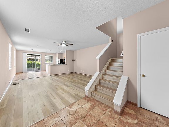 Living room view and open kitchen. Also Stair and big storage/utility room