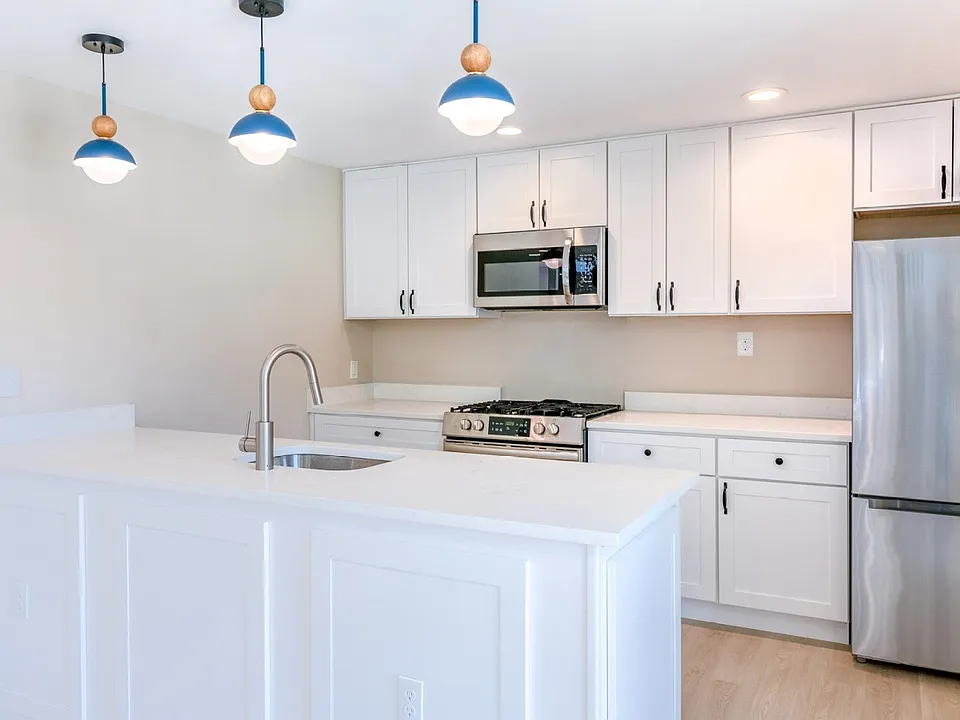Elevate your lifestyle at Lakeshore Preserve, where this modern kitchen features sleek white cabinetry, stylish pendant lights, and top-of-the-line appliances. Ready to make this culinary dream a reality? Schedule your tour today!
