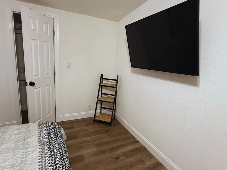 Smart TV with Netflix included and a convenient accent side table.