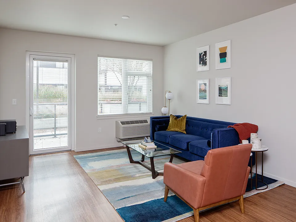 Grant Park Village living room shot with blue couch and orange leather chair