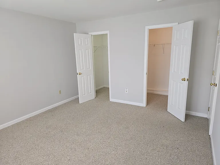 Primary bedroom with 2 walk in closets