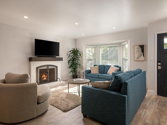 Bay windows and fireplace add charm to the living rom area
