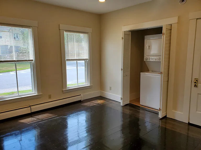 This bedroom faces south and has a laundry center and closet