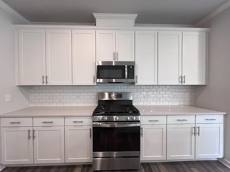 Generous white cabinets with ample quartz counter space, All new kitchen appliances