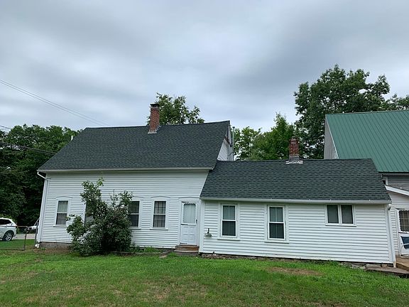 Side yard, chain link fencing on all sides with large gate to front of house and smaller gate to lower yard