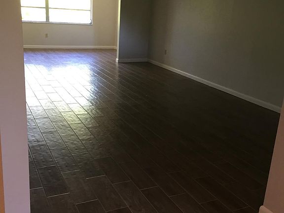 View from entry hall through living/dining area to sun room.