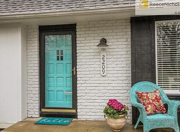 Expanded front porch allows a generous area to sit, relax and enjoy the charming tree lined street.