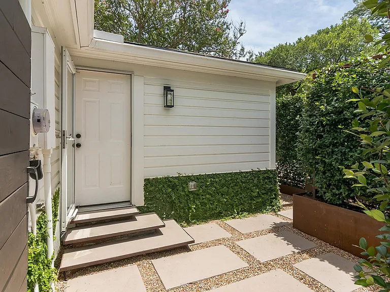 Backdoor to hallway in house. Featured privacy trellis and steel boxes between house and owner's private casita. View from gate and driveway.
