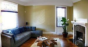 living room with ventless fireplace and orig stained glass accent on windo