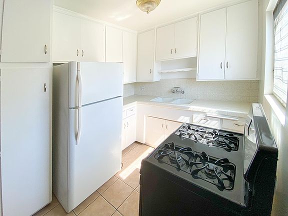 Kitchen with generous amounts of cabinet and includes stove and refrigerator.