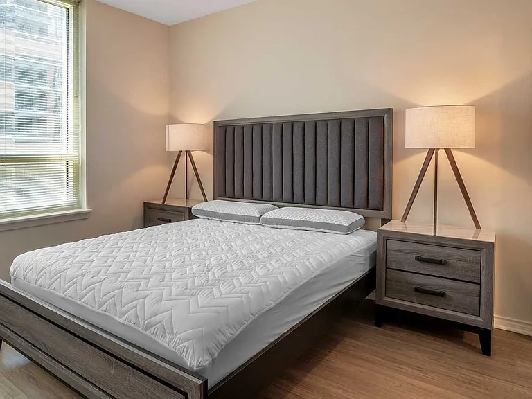Furnished+ apartment homes feature queen bed with mattress, two pillows, dresser, nightstands, lamp, and mirror. (Representative Image exact items and style of furnishings may vary)