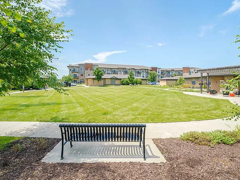 Enjoy peaceful green space with walking paths and benches thoughtfully placed for relaxing outdoors.