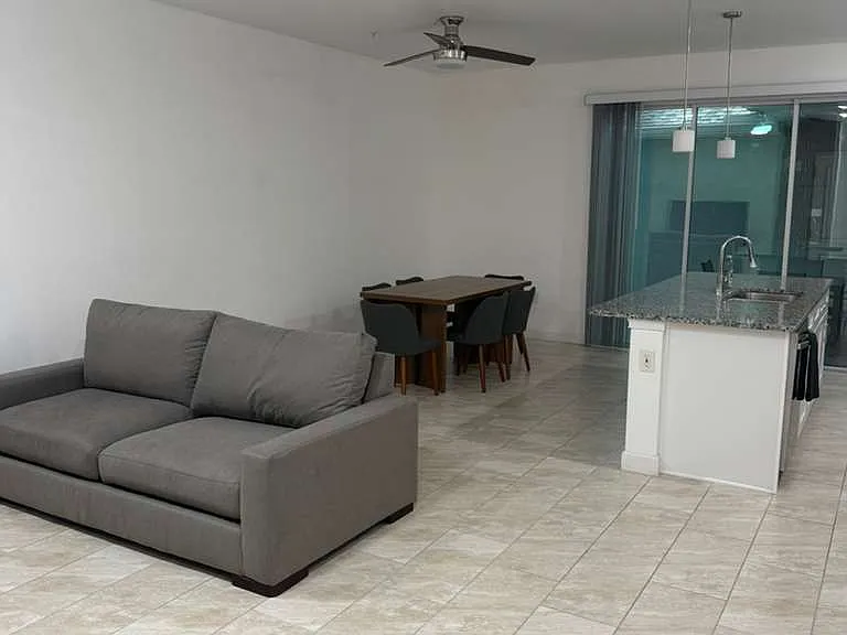 Living room with confortable sofa, dining table and 6 chairs