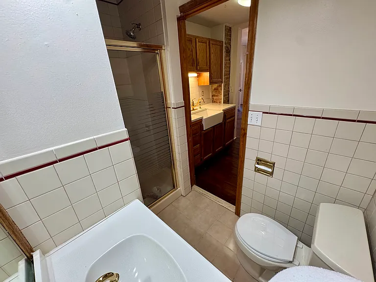 Simple studio flow with living space opening to galley kitchen opening to bathroom.