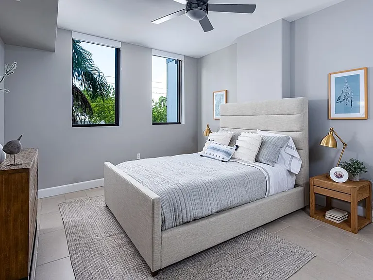 Spacious bedroom with hard surface flooring and ceiling fan