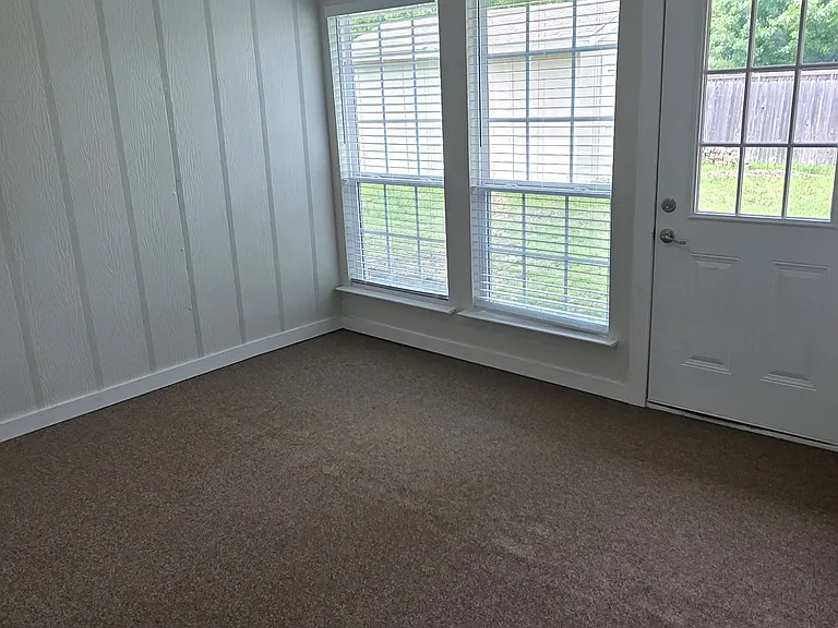 enclosed 14 by 15 porch with central air and heat and ceiling fan with new exterior carpet