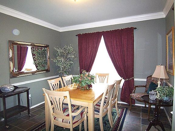 Formal dining features crown and chair railing.