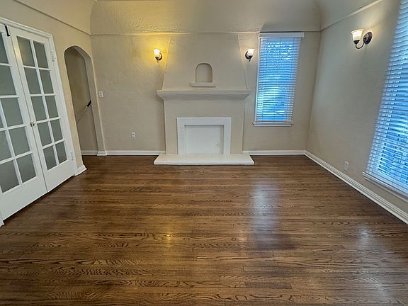 Unit 5 living room with faux fireplace and closet on left.
