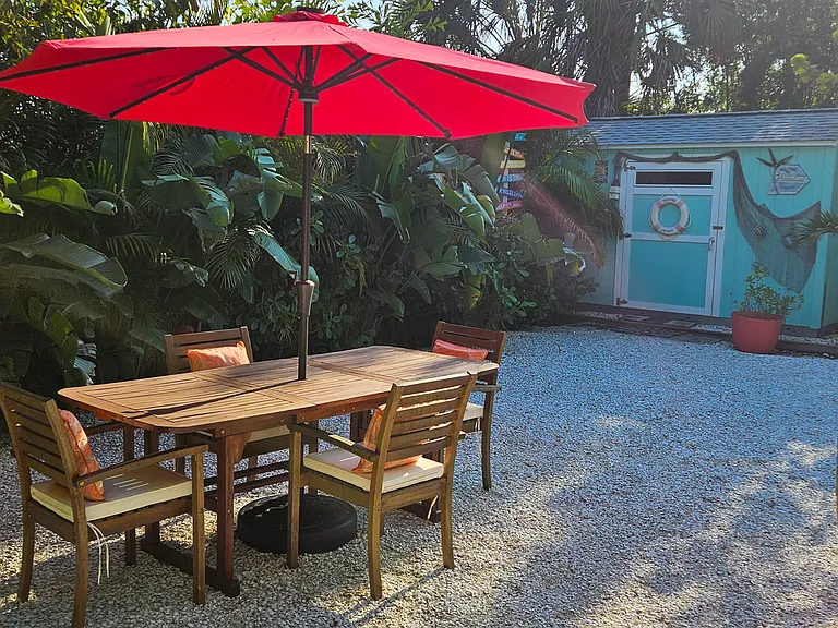 Table and chairs with lighted umbrella