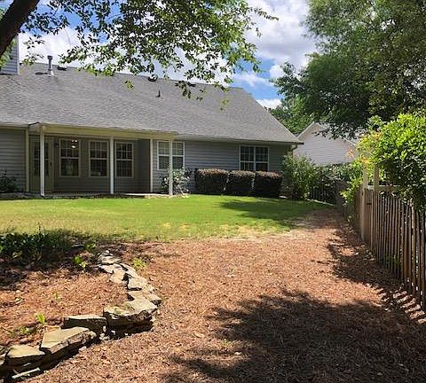 fenced yard with sunny and shady areas to hang out