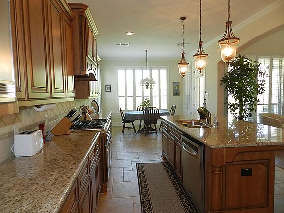 Gourmet Kitchen with tons of custom cabinets, granite counter tops with bull-nosed edges, tile back 