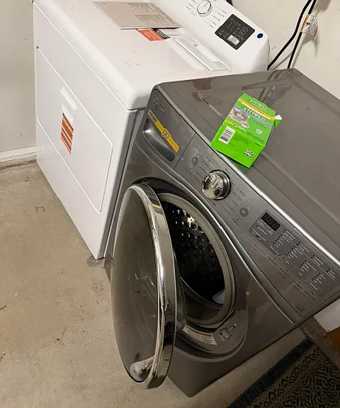 In-unit laundry zone featuring high-capacity, modern front-loading washer and a brand new dryer.