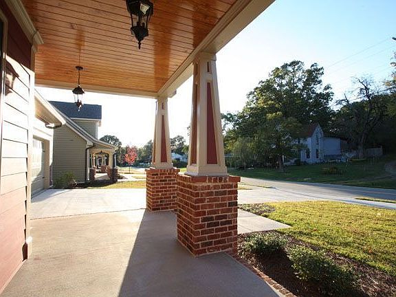 Concrete Front Porch With Stained Tongue & Groove Ceiling, Tapered Columns.