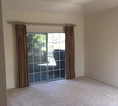 Formal living room with small patio and deck to back yard