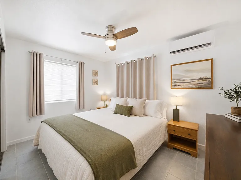 PRIMARY BEDROOM (King Size Bed)
Comfortable furnishings and blackout curtains help create a restful retreat after a busy day.