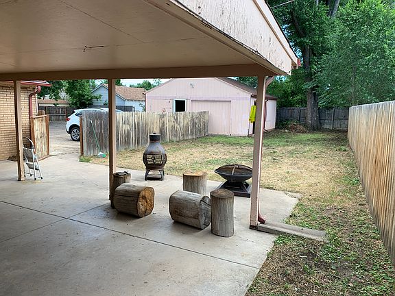 Backyard with covered patio and secure fenced yard