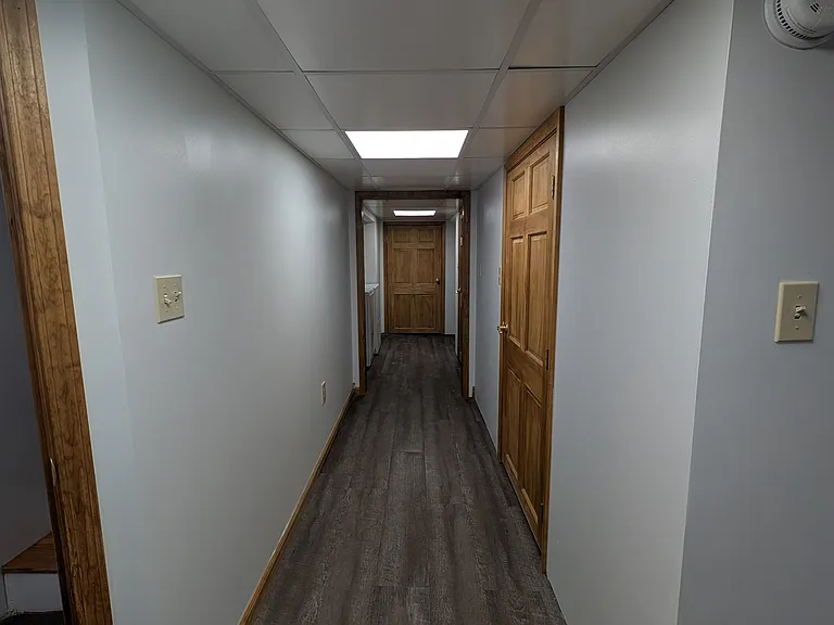 Finished basement hallway, 2 storage closets on the right and laundry on the left