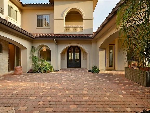 An impressive courtyard welcomes you to the double front doors.