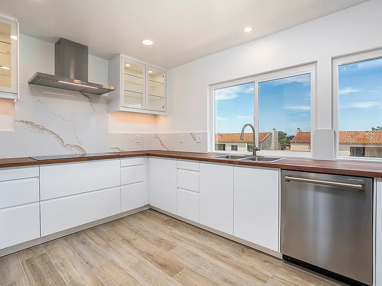 Fully remodeled kitchen, new appliances, wood countertops, and stone backsplash surrounds the entire length of the countertop and new energy efficient windows.