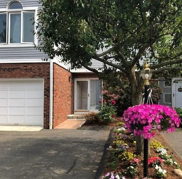 Entrance to the unit, and one car garage on the left