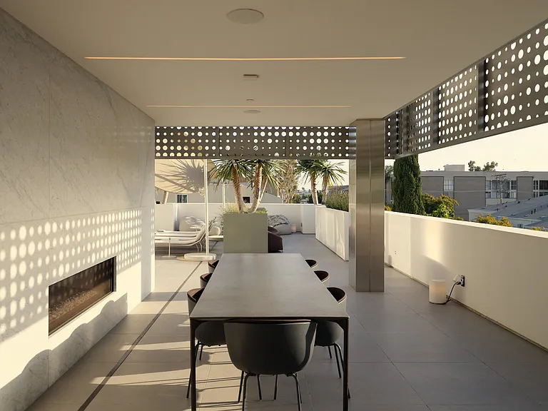 Exclusive Outdoor Lounge & Dining Terrace _ Available for Private Events _ This elevated terrace offers residents a refined setting for social gatherings, featuring a built-in fireplace, expansive dining area, and panoramic city views.