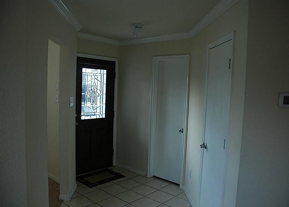 Entry door and foyer.  Half bath on right and study on left.