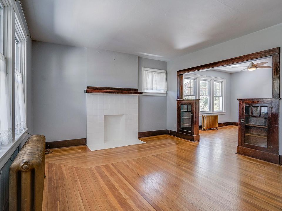 Living Room w/ hardwood floors & decorative woodworking