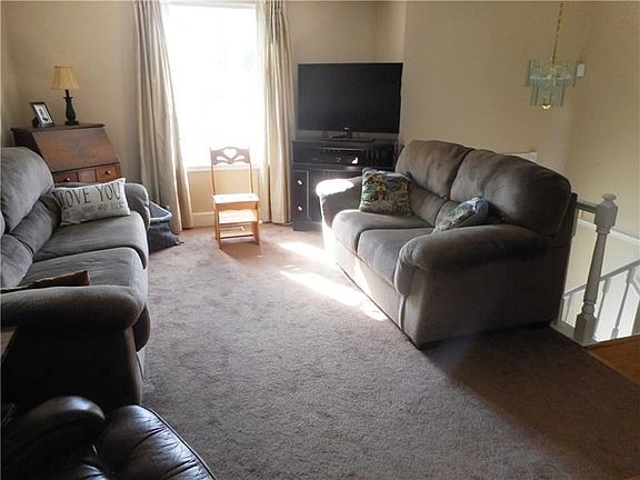 Living Room: The bay window invites natural, vibrant sunlight to gleam into the living room.