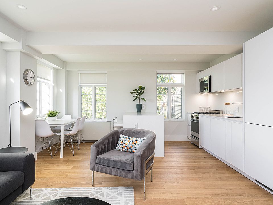 open concept living and dining room with hardwood floors