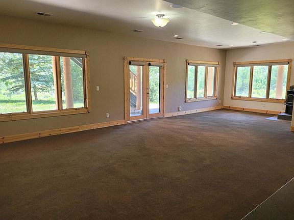 Large open-concept living area and kitchen, with lots of windows.