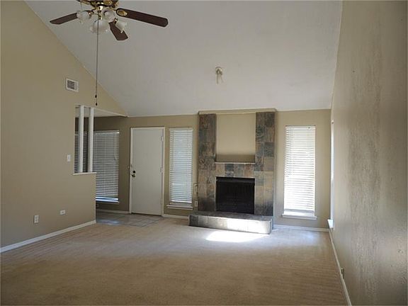 Spacious family room with vaulted ceiling and new slate front on fireplace