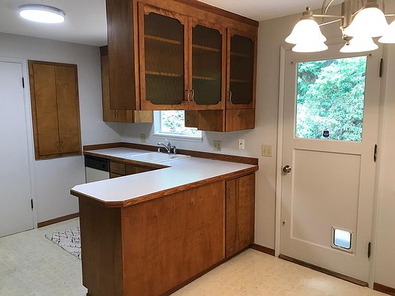 Cheery kitchen with lots of cabinet space. New dishwasher being installed. Door to back yard has a cat door.