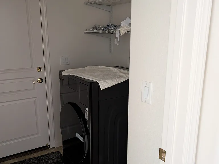 laundry room has new wood look tile floors