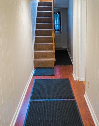 Hallway with runners over hardwood floors